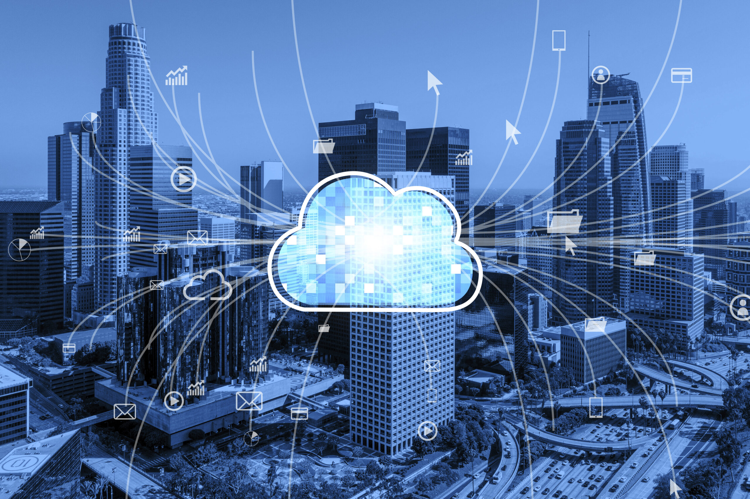 Blue-tinted cityscape with a digital cloud icon at the center. Various technology symbols and network lines connect, illustrating cloud computing.