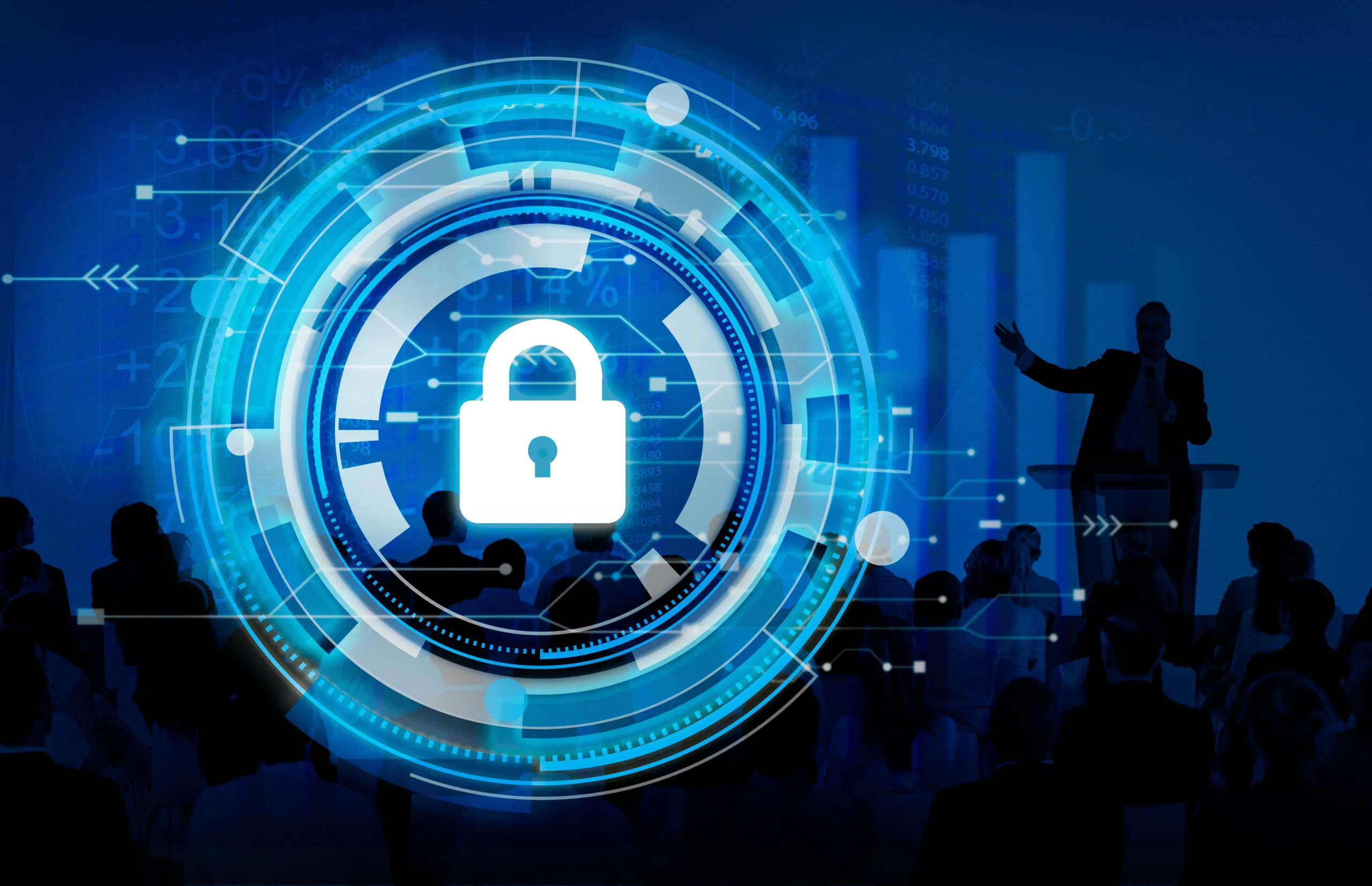 A blue digital padlock and circuit design overlay a silhouette of a speaker addressing a crowd, symbolizing cybersecurity in presentations.Cyber protection,netsectechnologies